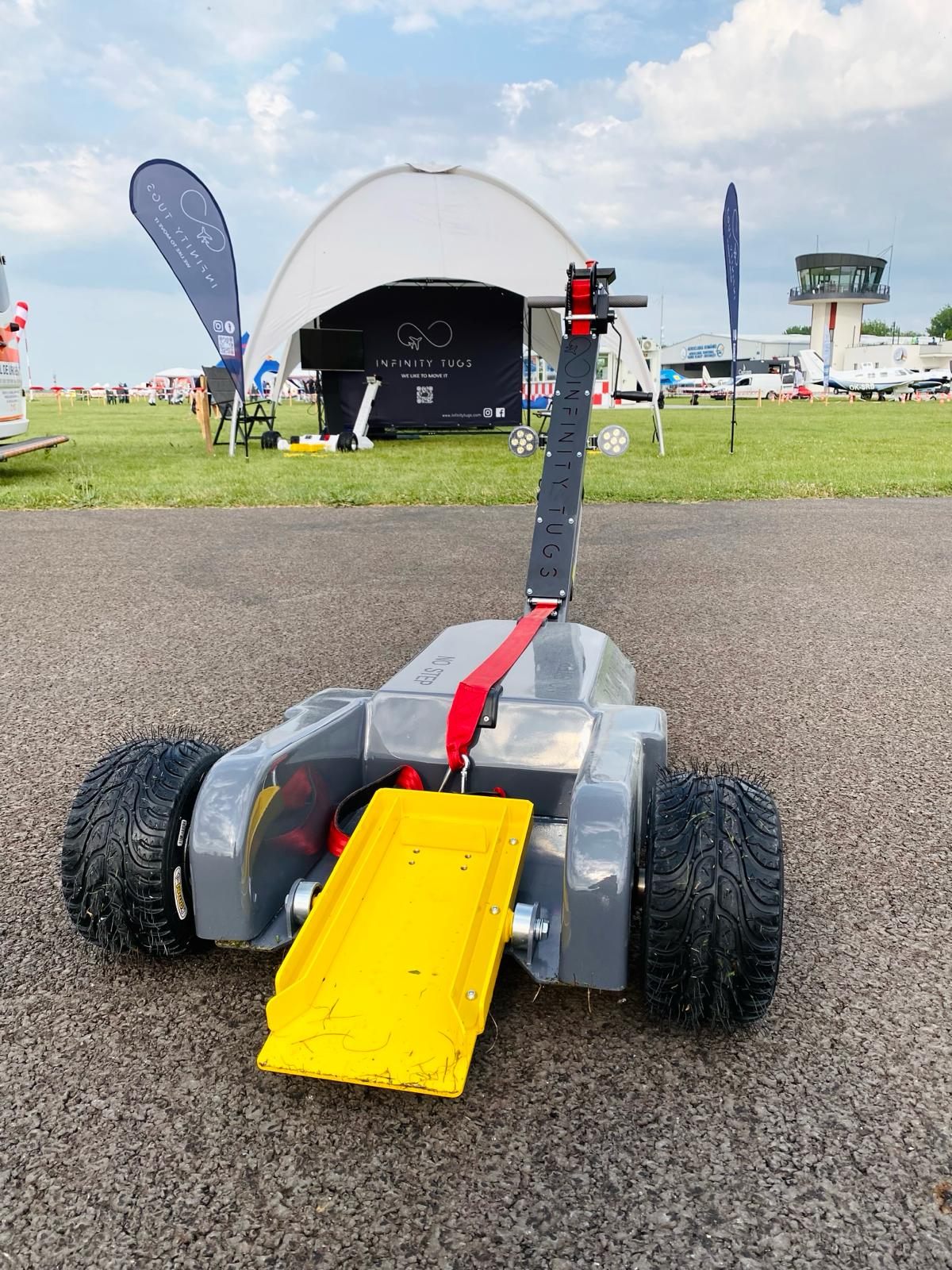 Infinity Tugs booth and electric aircraft tugs on display at an aviation trade show