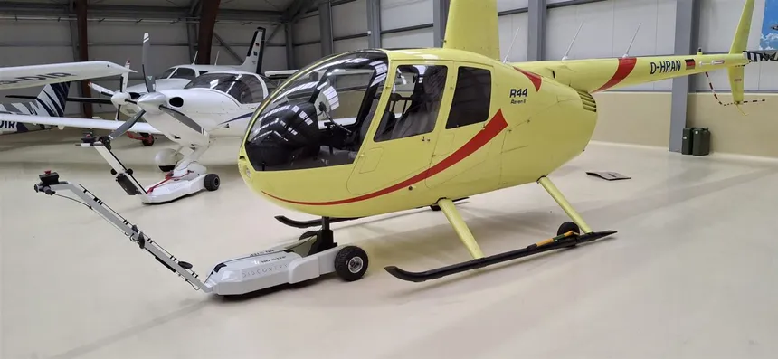 DISCOVERY H electric helicopter tug positioned under a helicopter skid